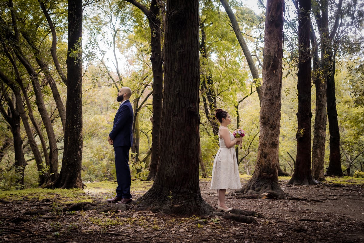 A Couple Standing Beside Green Trees